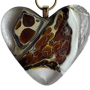 Animal design featured on heart shaped glass fused pendant. 18"